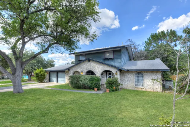 a front view of a house with a garden