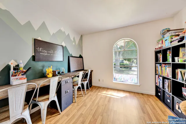 a view of a dining room with furniture and a book shelf