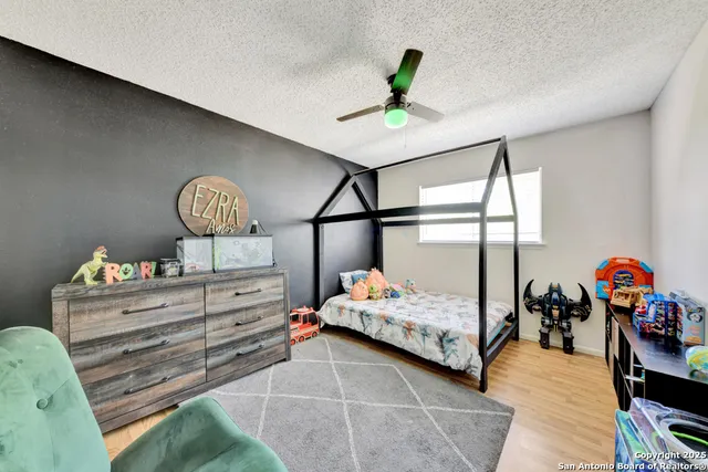 a bedroom with a bed and ceiling fan