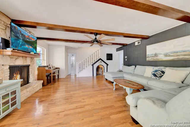 a living room with furniture and a fireplace