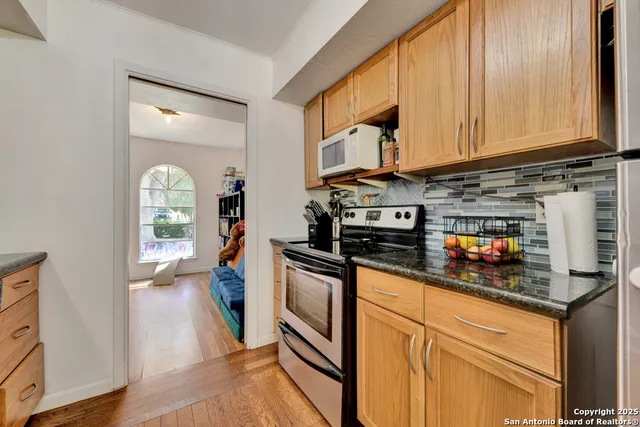 a kitchen with stainless steel appliances granite countertop a stove and a microwave
