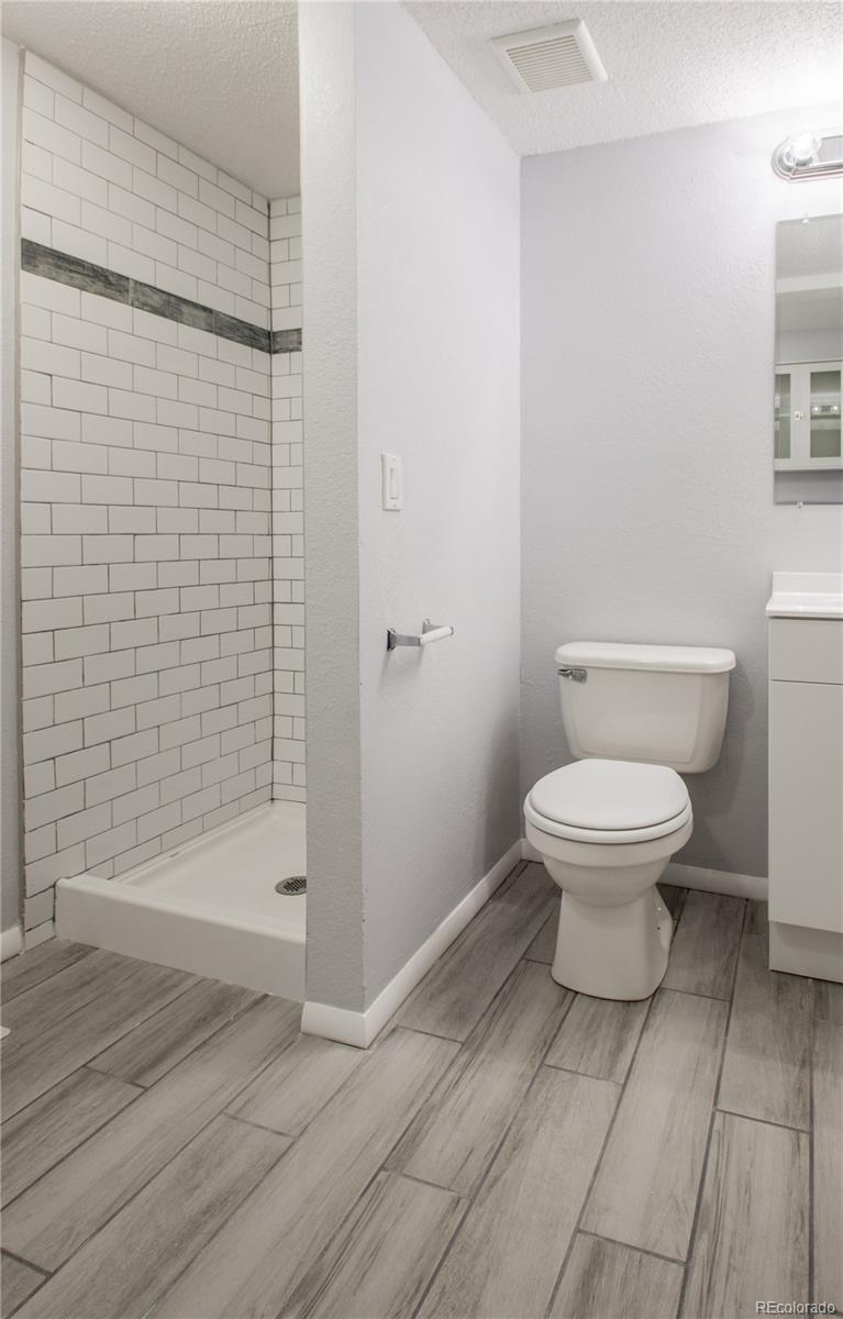 13309 Birch Circle Thornton, CO 80241 - Photo 17 of 25 a bathroom with a toilet and a shower