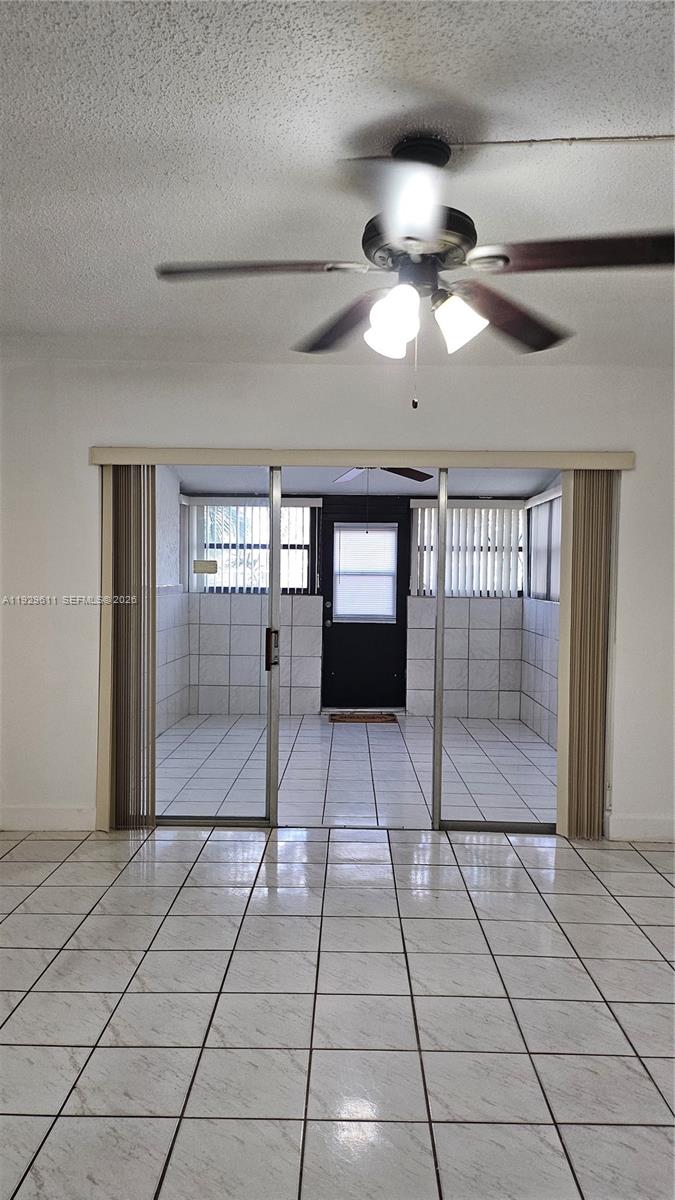 10641 Southwest 108th Avenue, Unit 1H Miami, FL 33176 - Photo 22 of 23 a view of empty room with wooden floor and fan