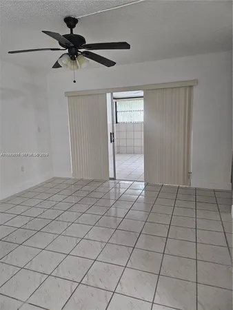 a view of a livingroom with a ceiling fan and window