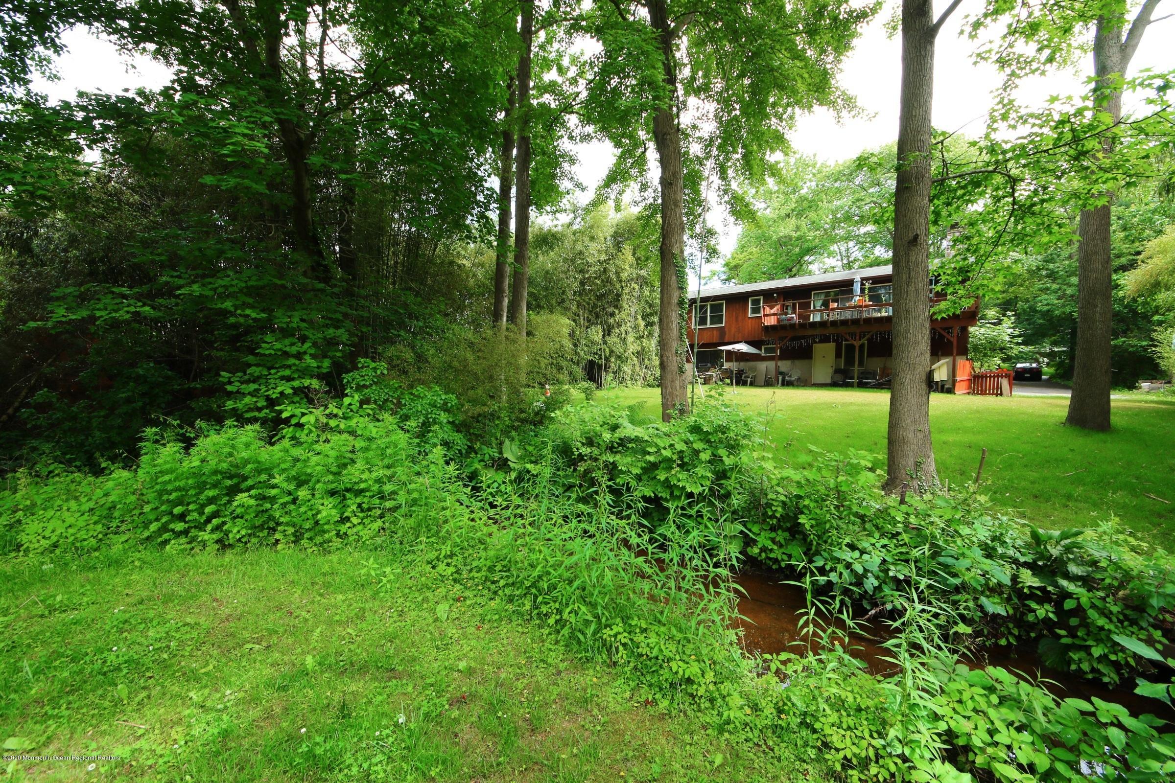657 Locust Point Road Atlantic Highlands, NJ 07716 - Photo 6 of 21 Backyard stream