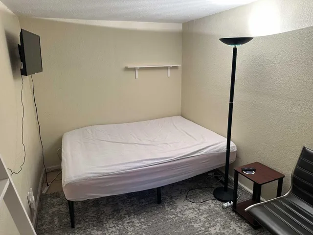 a bed sitting in a room next to a window