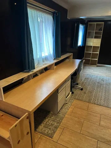 a room with wooden floor and furniture