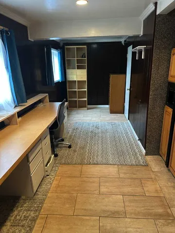 a room with a bed and a flat screen tv