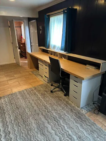 a room with chair and mirror