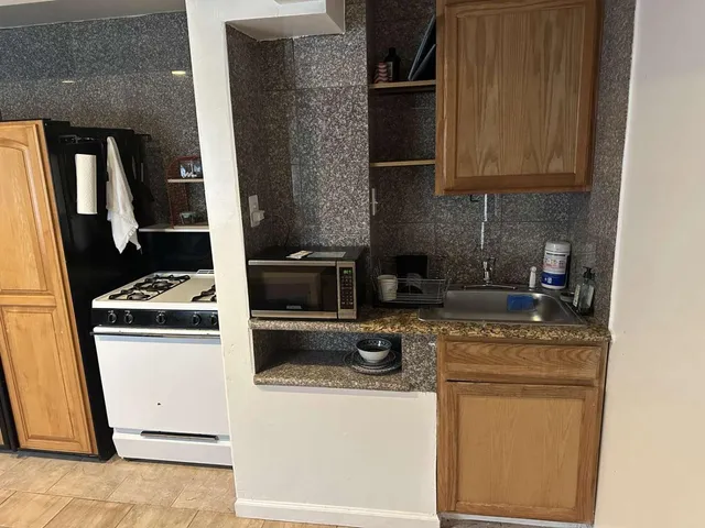 a kitchen with appliances a sink and cabinets