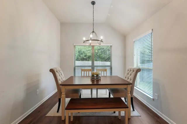 a dining room with furniture and window