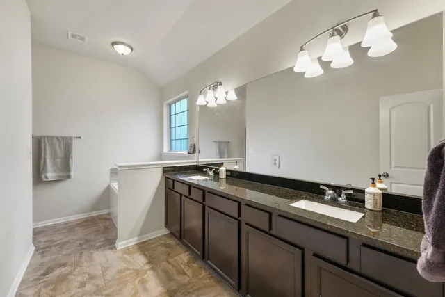 a view of a double sink and a mirror