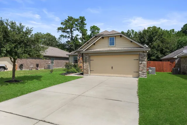 a front view of house with yard and green space