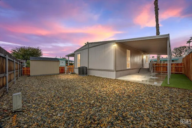 a view of a house with wooden fence