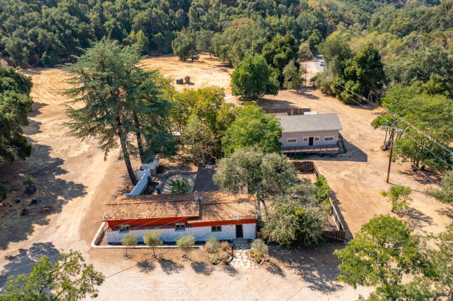 an aerial view of a house with a yard basket ball court and outdoor seating