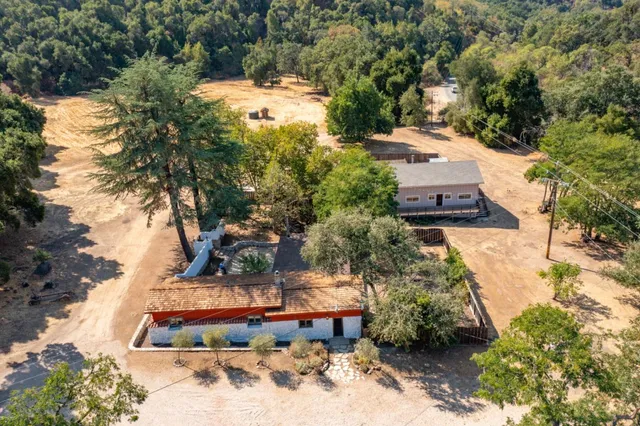 an aerial view of a house with a yard basket ball court and outdoor seating