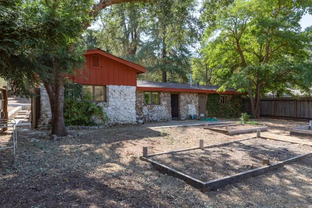 a backyard of a house with lots of trees
