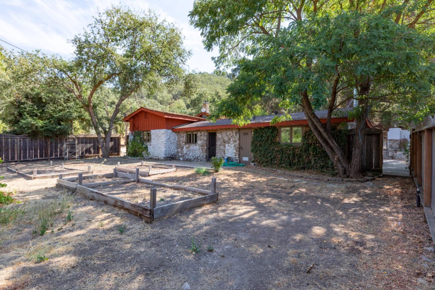 20500 Cachagua Road Carmel Valley, CA 93924 - Photo 36 of 66 a view of a house with backyard and a tree