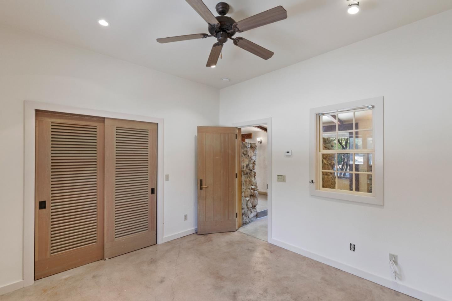 20500 Cachagua Road Carmel Valley, CA 93924 - Photo 51 of 65 an empty room with windows and fan