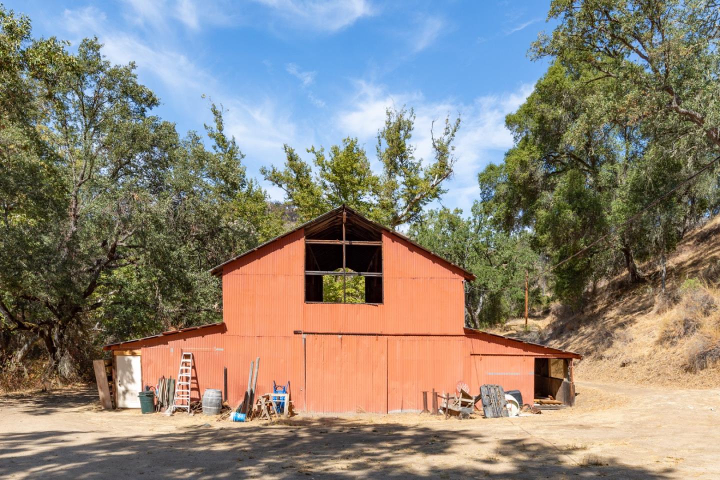 20500 Cachagua Road Carmel Valley, CA 93924 - Photo 65 of 65 a backyard of a house with lots of trees