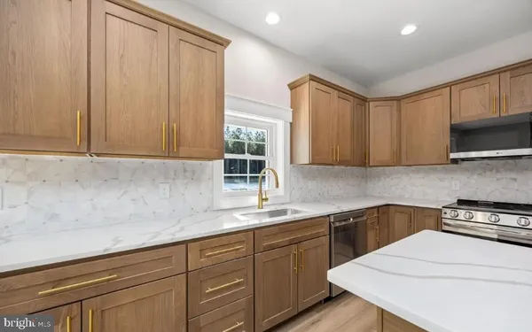 a kitchen with a sink cabinets and window