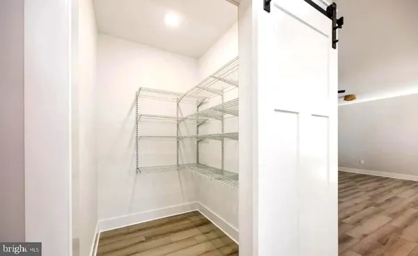 a view of a room with wooden floor