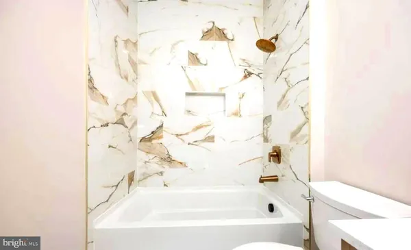 a bathroom with a bathtub and a shower