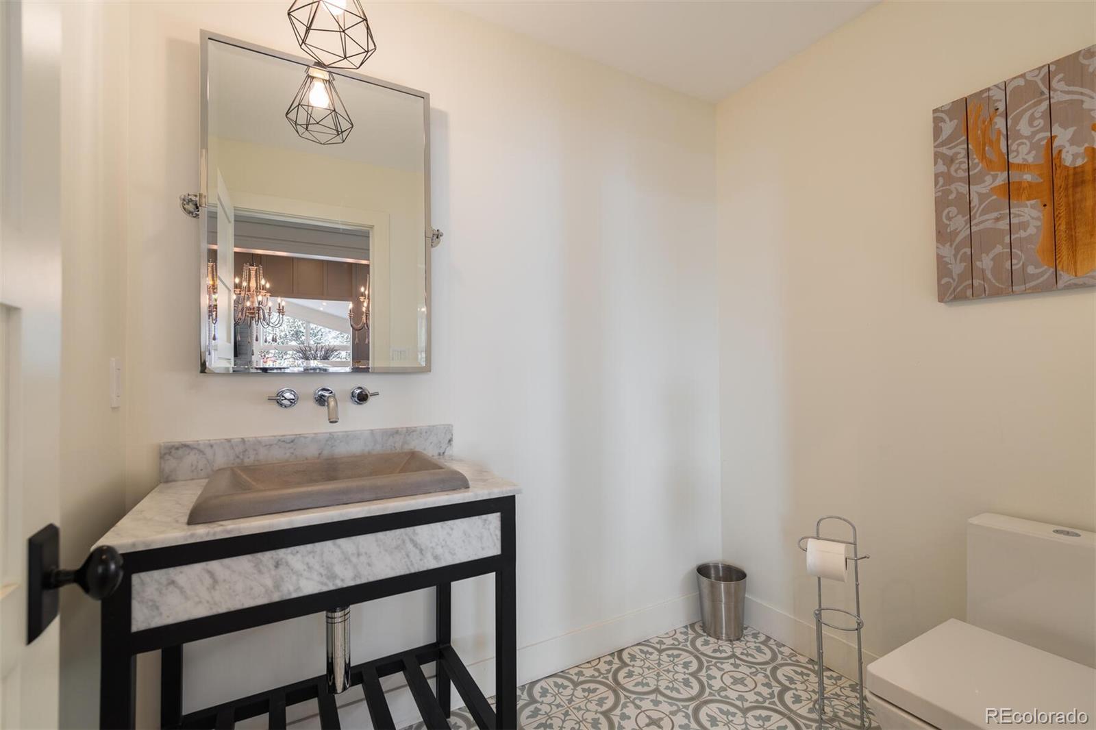 1791 Kerr Gulch Road Evergreen, CO 80439 - Photo 13 of 40 a bathroom with a sink a toilet and mirror