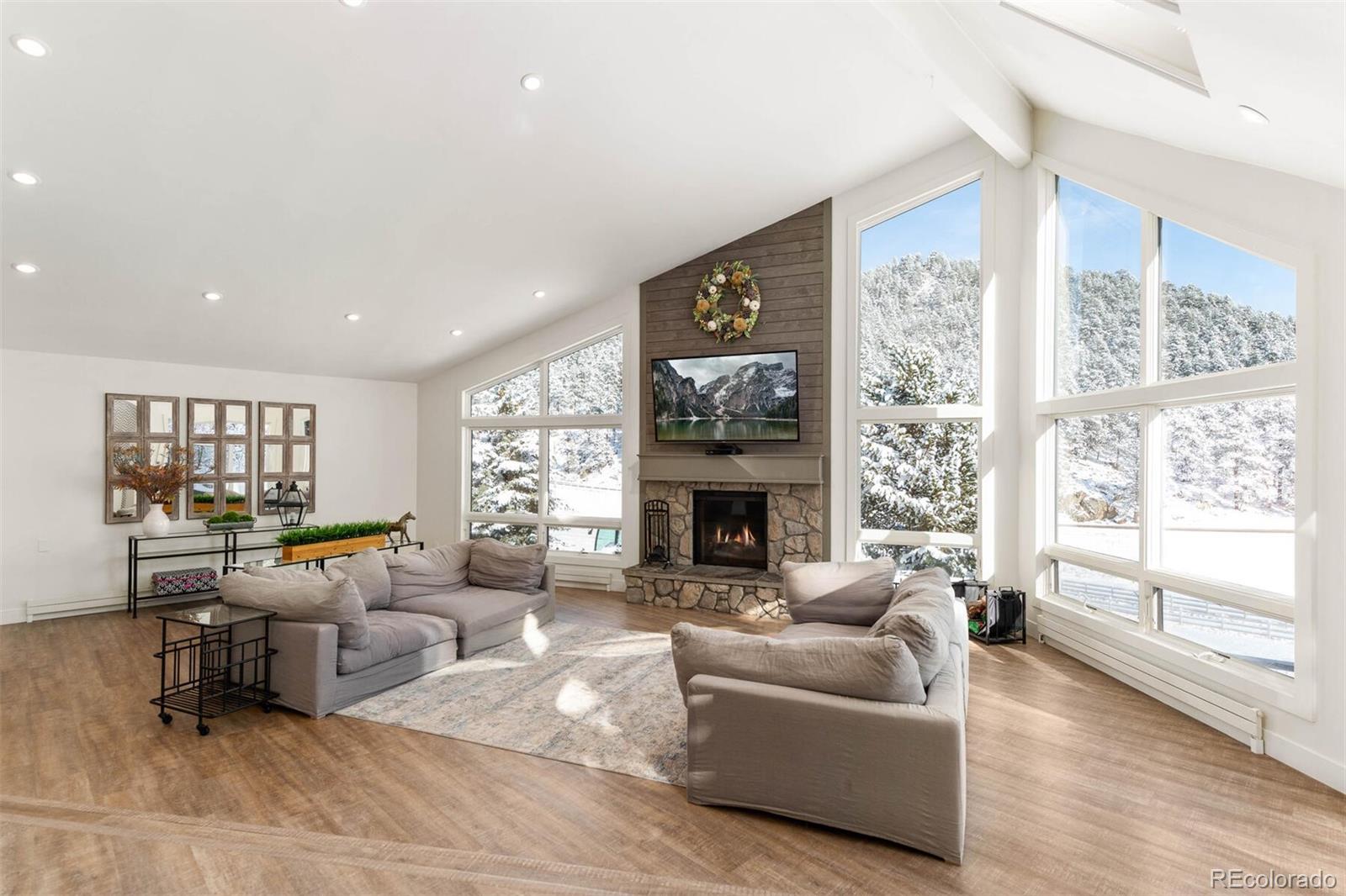 1791 Kerr Gulch Road Evergreen, CO 80439 - Photo 3 of 40 a living room with furniture and a fireplace