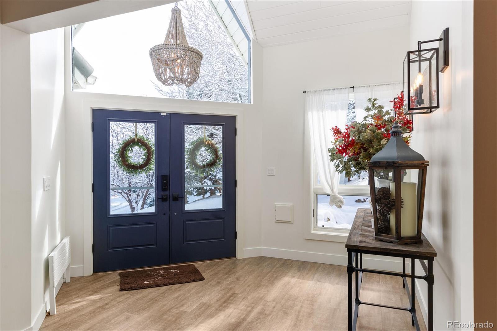 1791 Kerr Gulch Road Evergreen, CO 80439 - Photo 33 of 40 a view of entryway with a front door and wooden floor