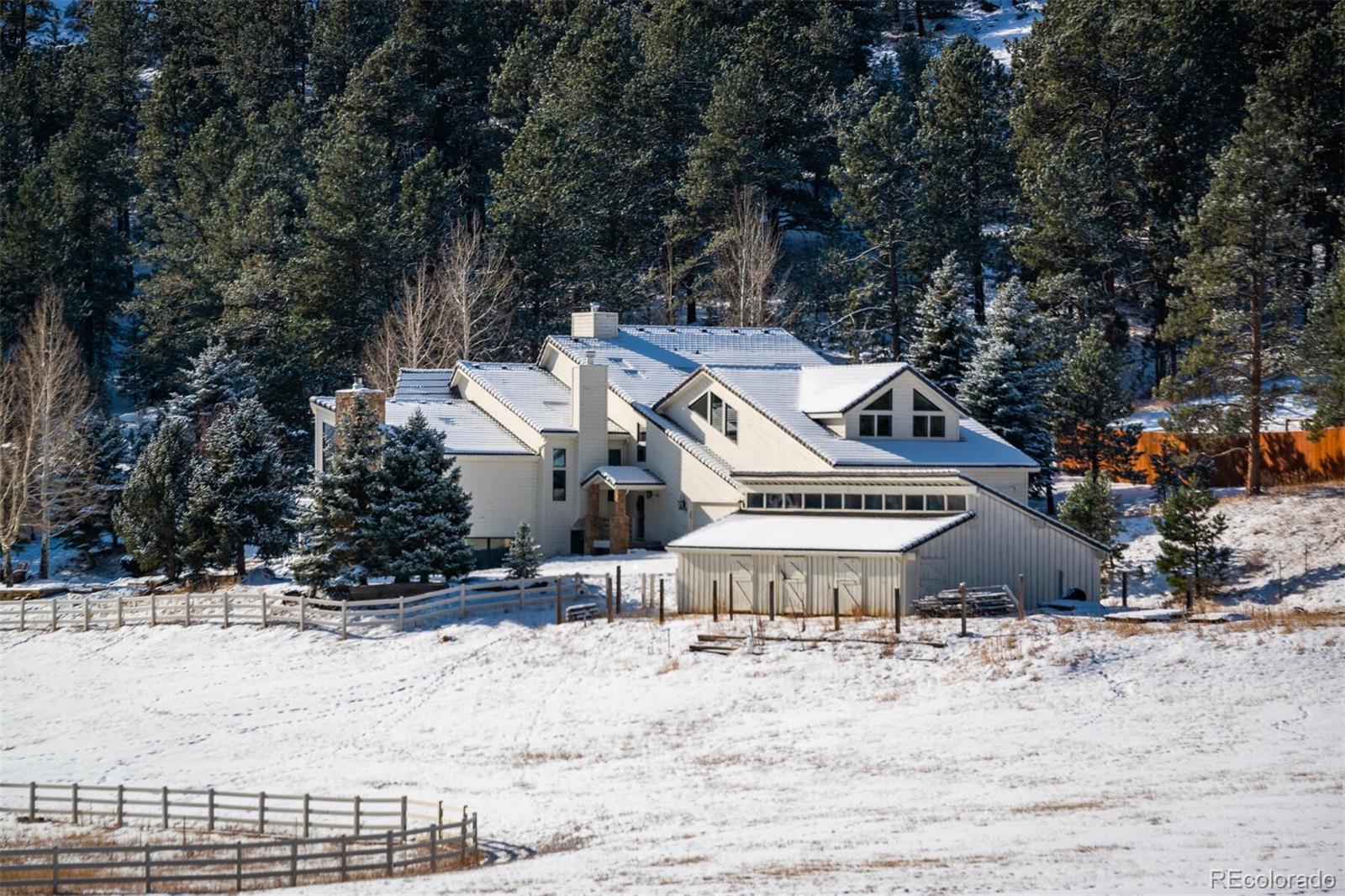 1791 Kerr Gulch Road Evergreen, CO 80439 - Photo 39 of 40 a view of a house with a yard covered in snow