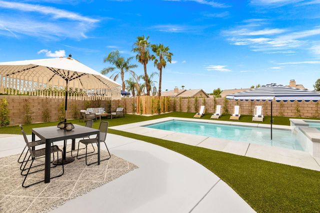 a view of swimming pool with outdoor seating and city view