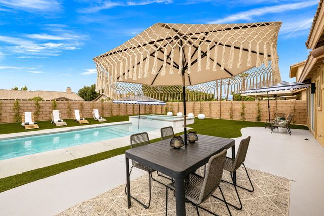 an aerial view of a house with garden space and street view