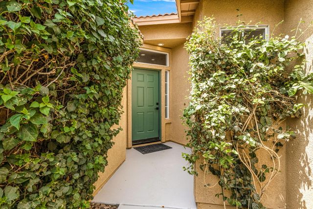 a dining room filled chandelier and kitchen view