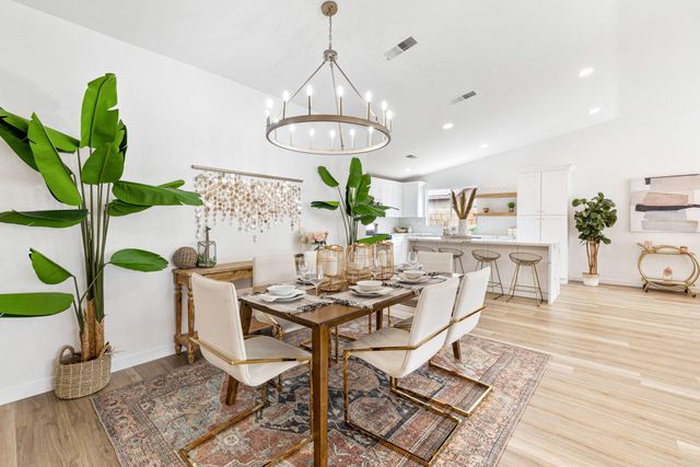 a living room with furniture and view of kitchen