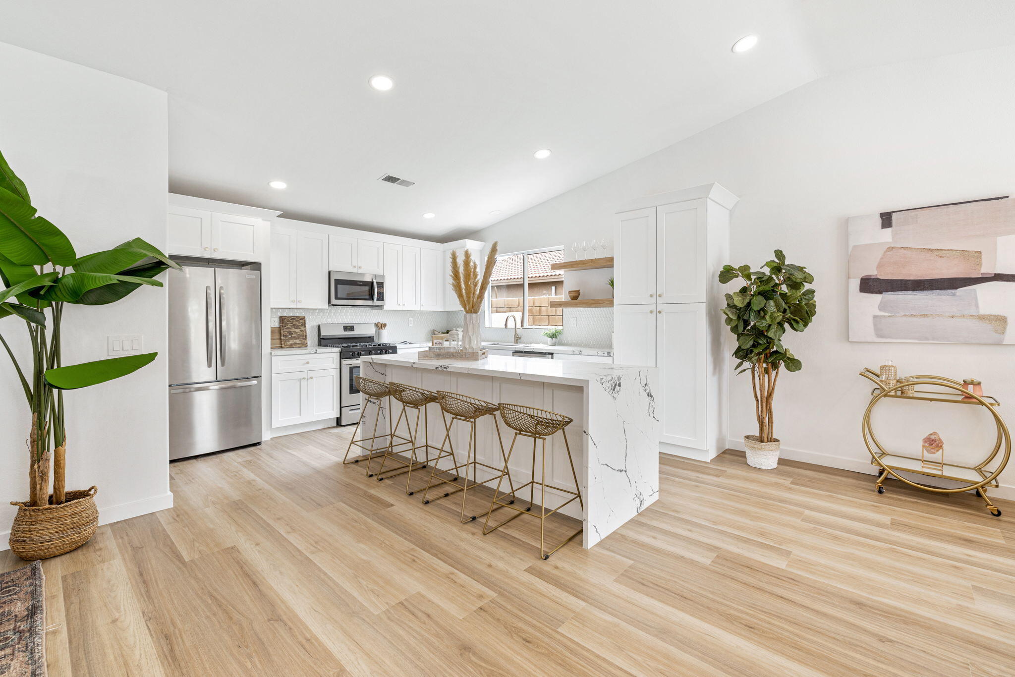 79340 Paseo Del Rey La Quinta, CA 92253 - Photo 31 of 69 a kitchen with white cabinets and stainless steel appliances