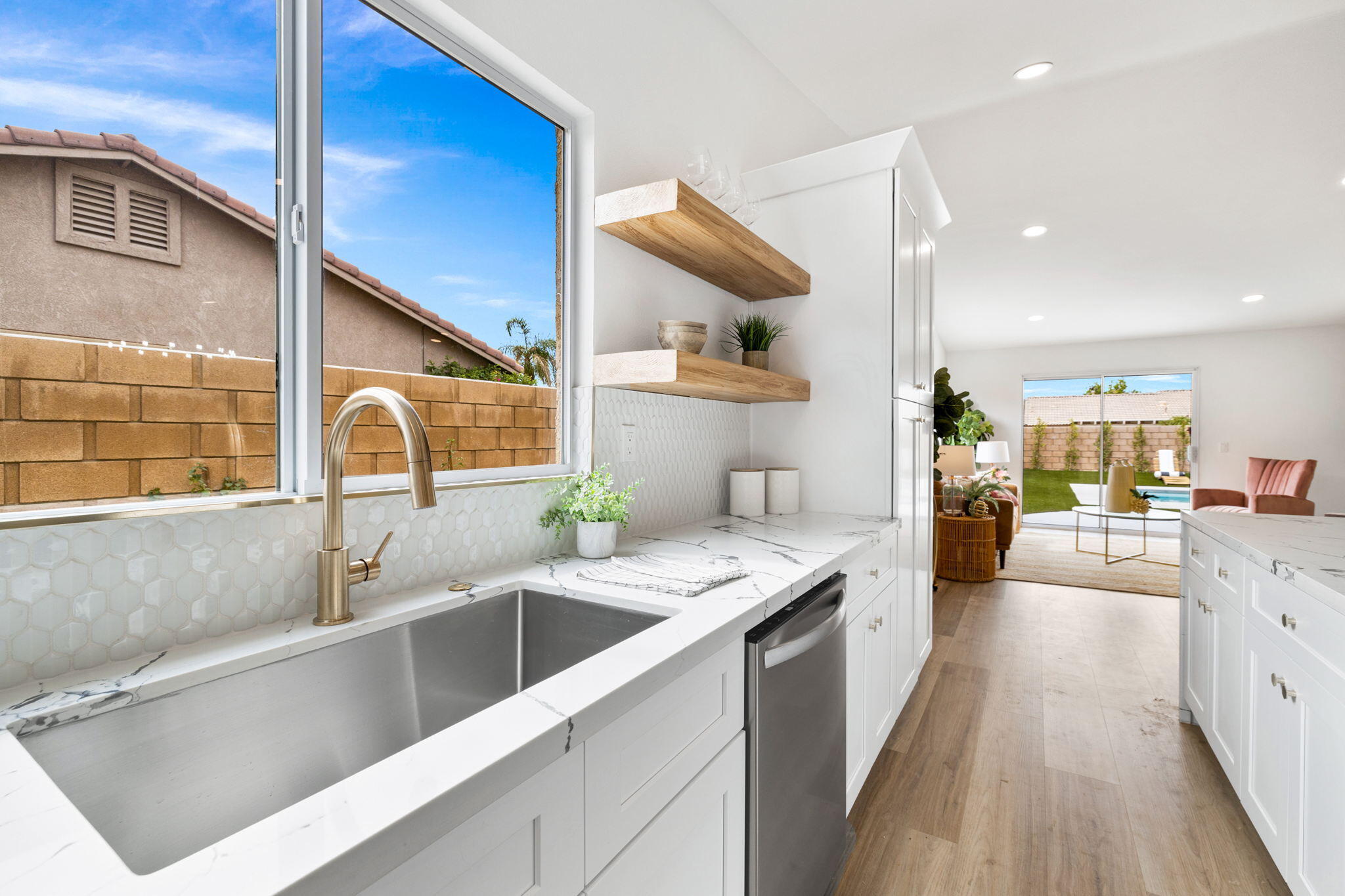 79340 Paseo Del Rey La Quinta, CA 92253 - Photo 40 of 69 a kitchen with a sink cabinets and wooden floor