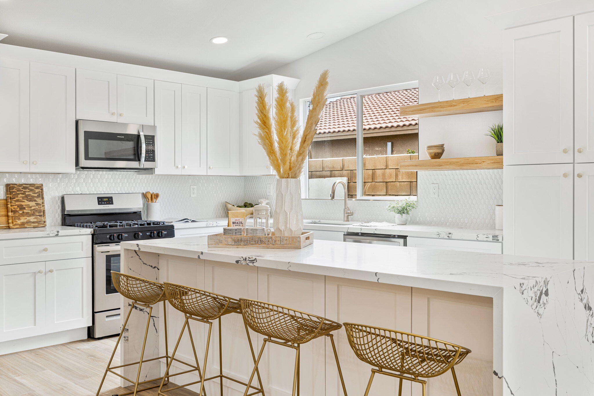 79340 Paseo Del Rey La Quinta, CA 92253 - Photo 41 of 69 a kitchen with stainless steel appliances a sink a stove a refrigerator cabinets and a dining table