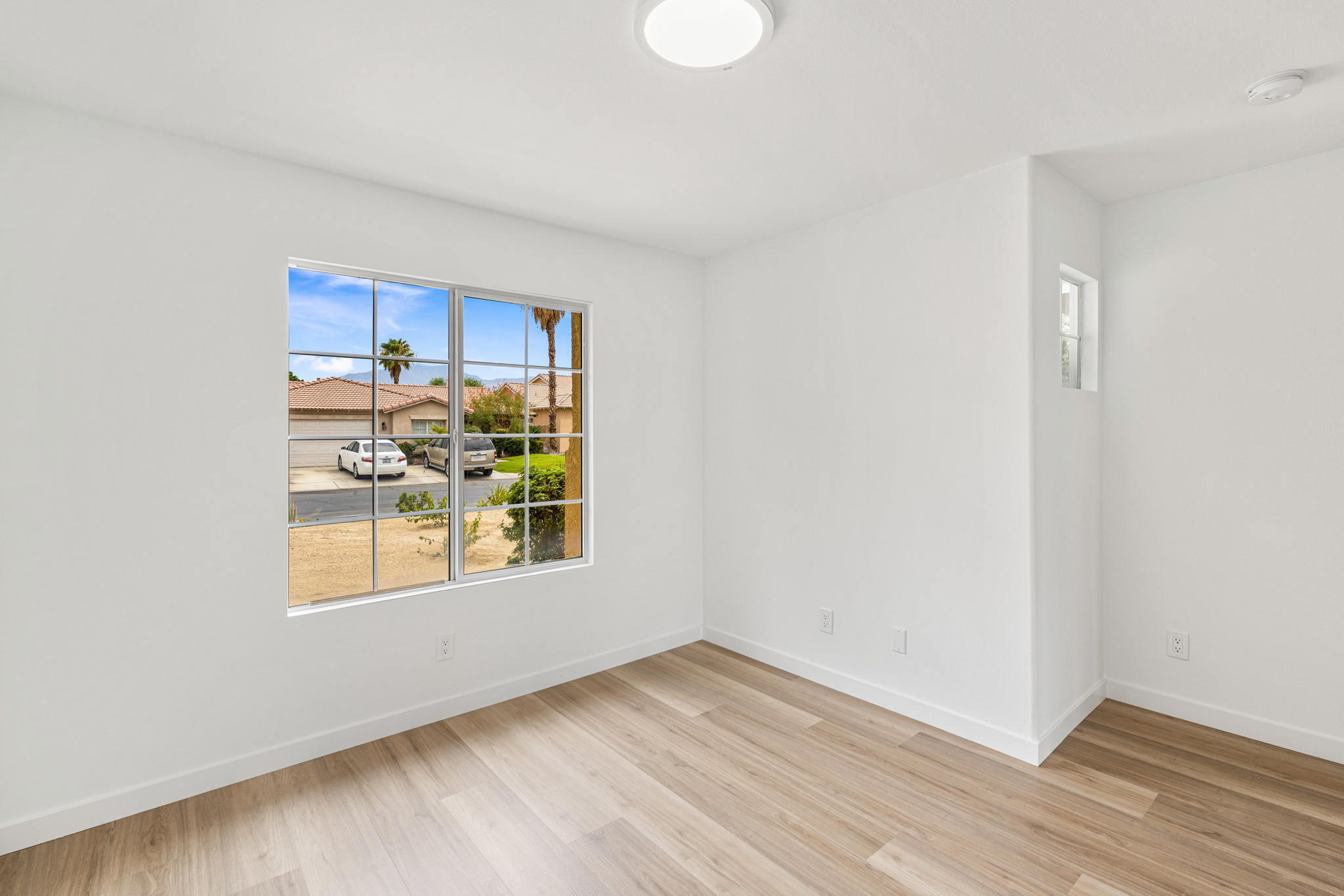 79340 Paseo Del Rey La Quinta, CA 92253 - Photo 64 of 69 an empty room with wooden floor and windows