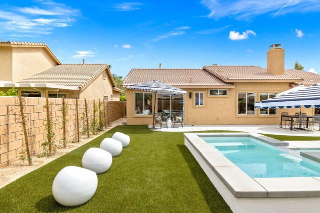 a view of a swimming pool with a lounge chair