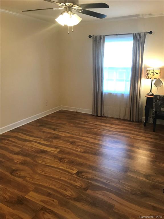 5941 Quail Hollow Road Charlotte, NC 28210 - Photo 15 of 20 an empty room with wooden floor and windows