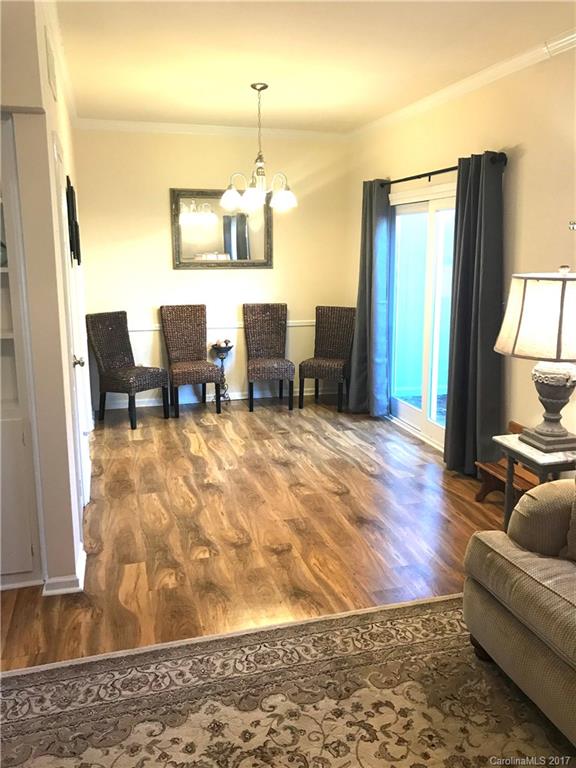 5941 Quail Hollow Road Charlotte, NC 28210 - Photo 4 of 20 a living room with couches chairs and kitchen view with wooden floor