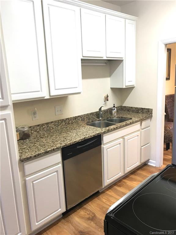 5941 Quail Hollow Road Charlotte, NC 28210 - Photo 8 of 20 a kitchen with granite countertop white cabinets and white appliances