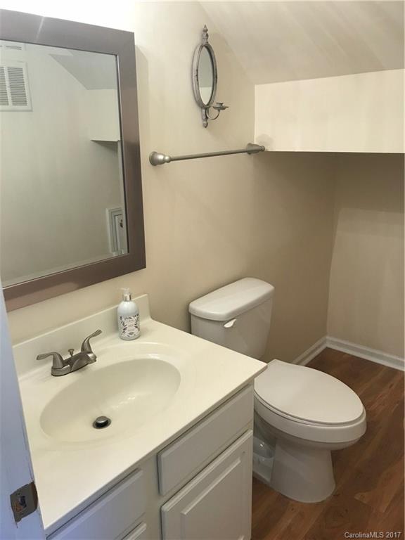 5941 Quail Hollow Road Charlotte, NC 28210 - Photo 9 of 20 a bathroom with a toilet sink and mirror
