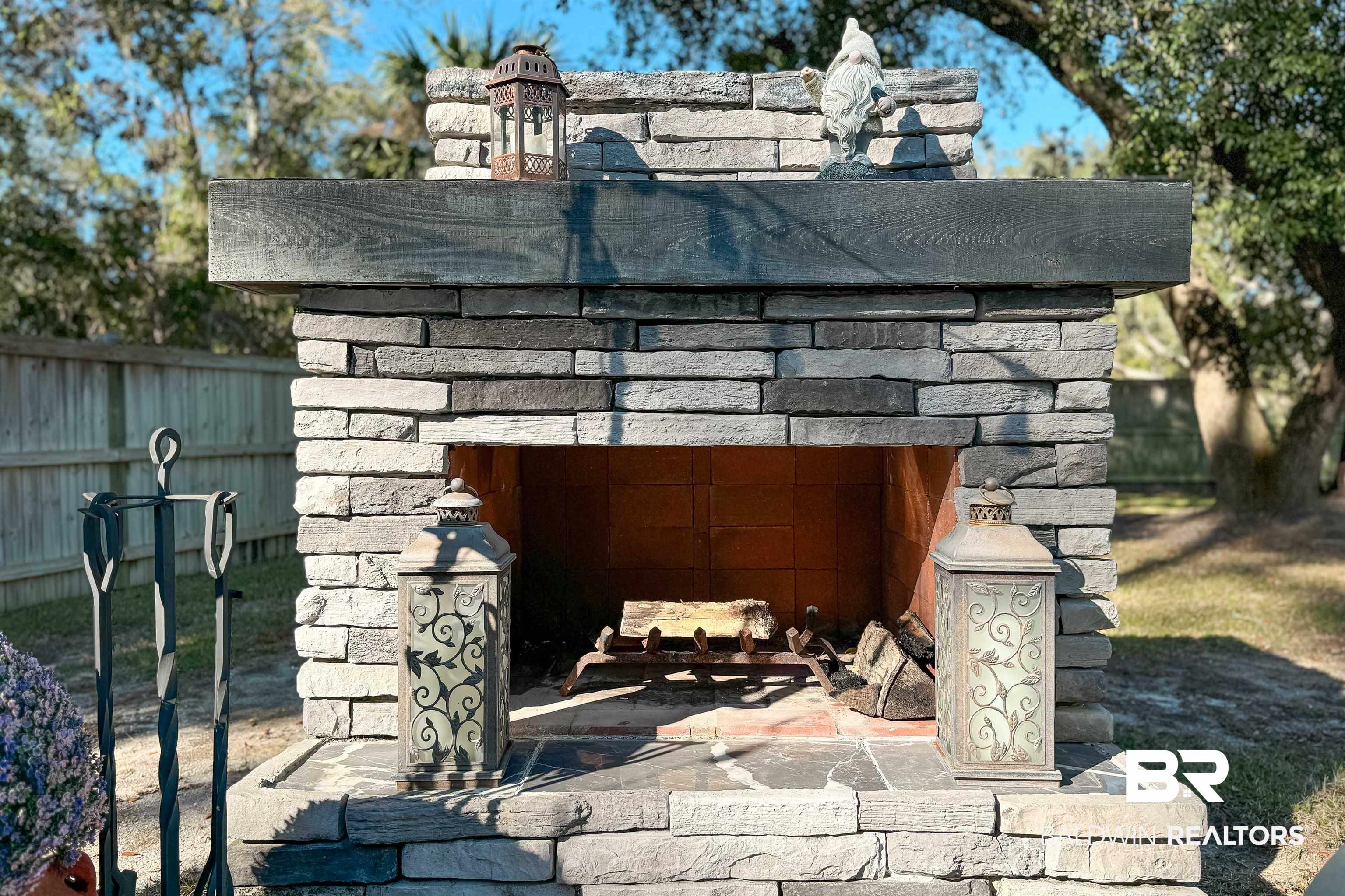 1290 Mako Loop Gulf Shores, AL 36542 - Photo 42 of 50 Exterior details with fence and an outdoor fireplace
