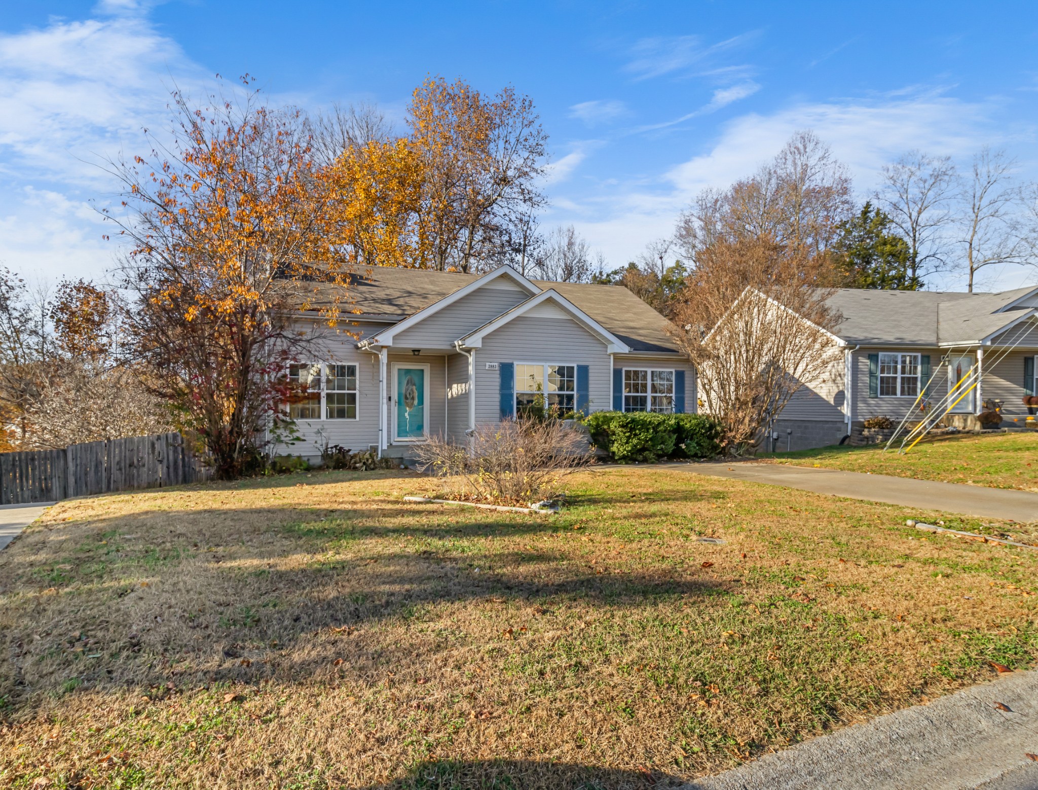 a front view of a house with a yard and ocean view