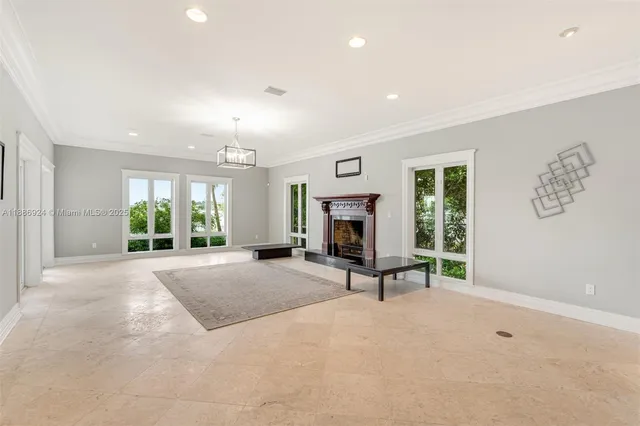a view of an empty room with a fireplace and a large window