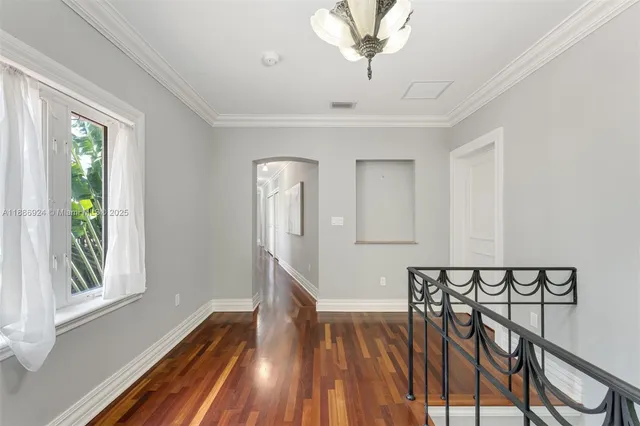 a view of a livingroom with furniture and hardwood floor