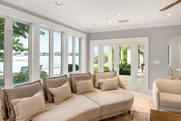 a spacious bedroom with a large bed couches and a large window