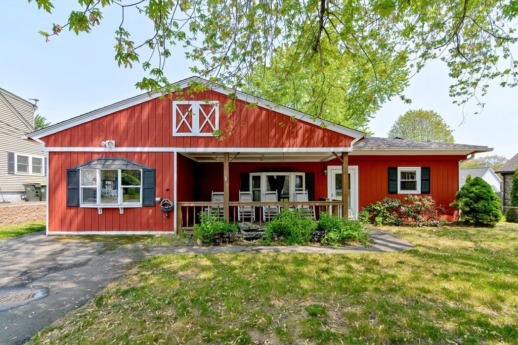 front view of a brick house with a yard